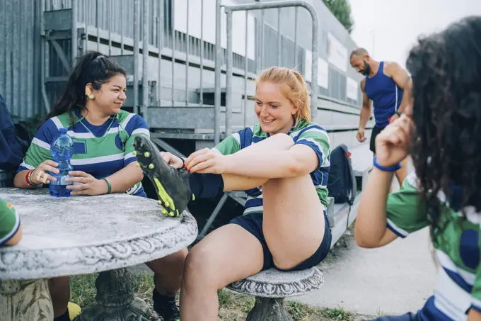 Teammates sharing a laugh during a rugby break