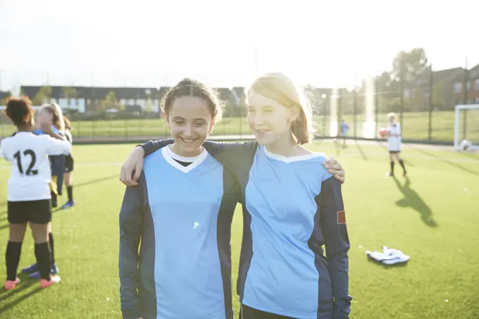 Two young soccer players sharing a moment on the field