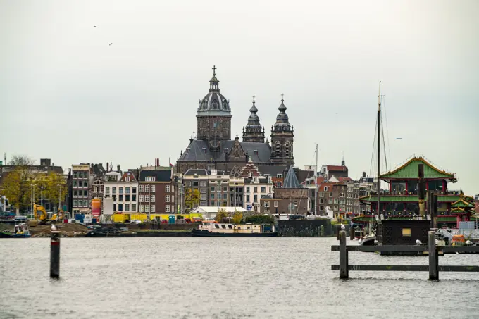 Amsterdam skyline featuring historic buildings and serene waterways.