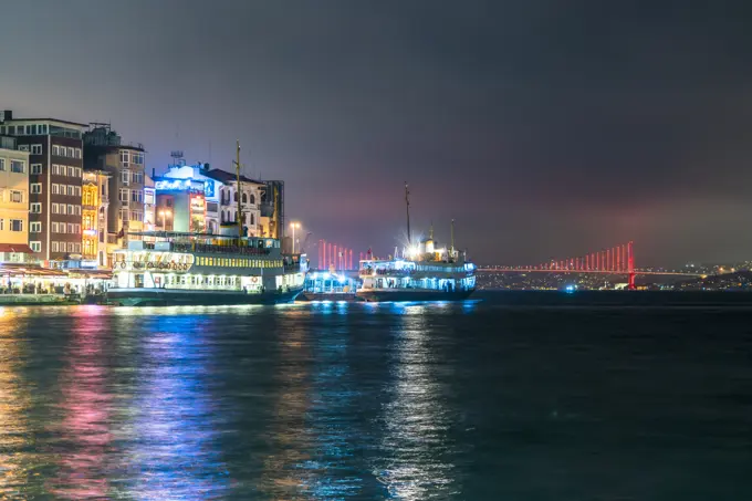 Turkey, Istanbul, Illuminated tour boats at night