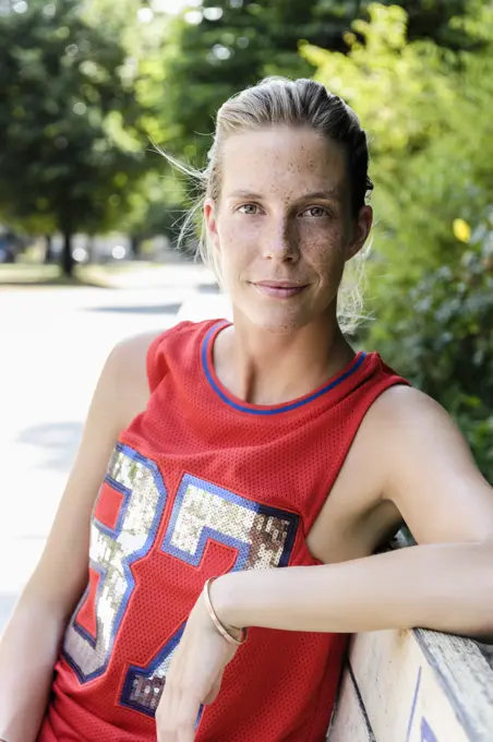 Portrait of female basketball player taking a break in park