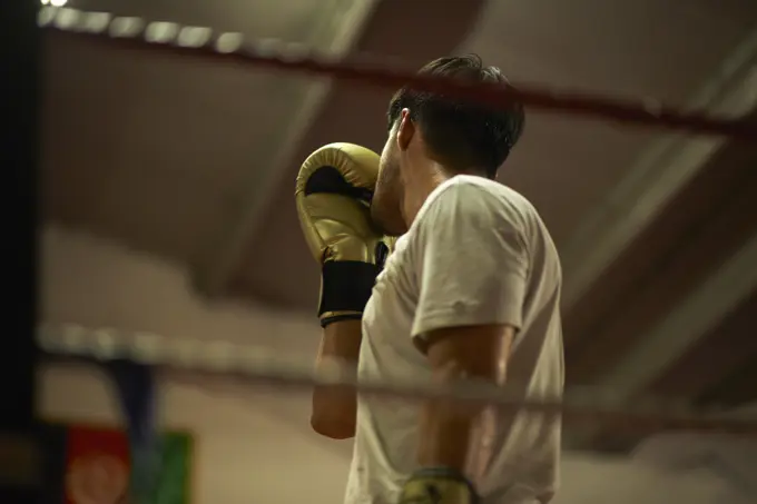 Boxer practising in boxing ring