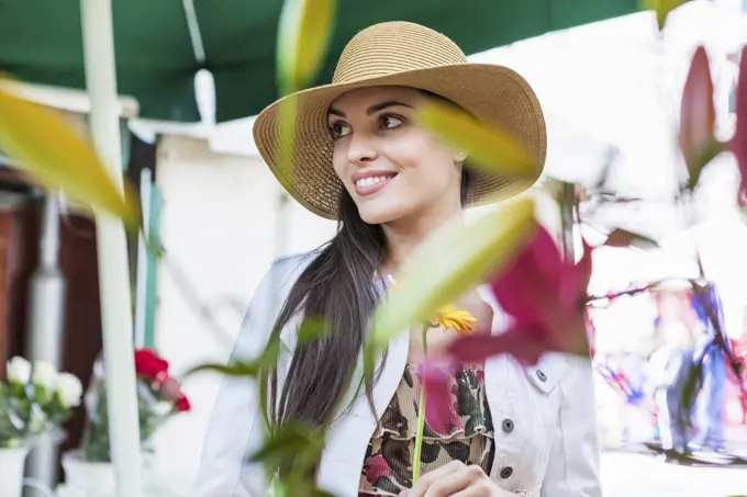 Young female tourist at flower market stall, Split, Dalmatia, Croatia