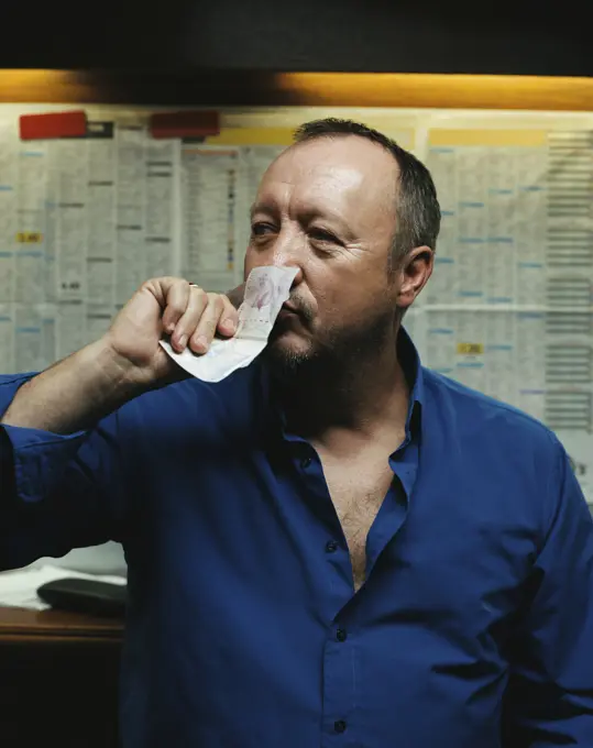 Man smelling a twenty pound note