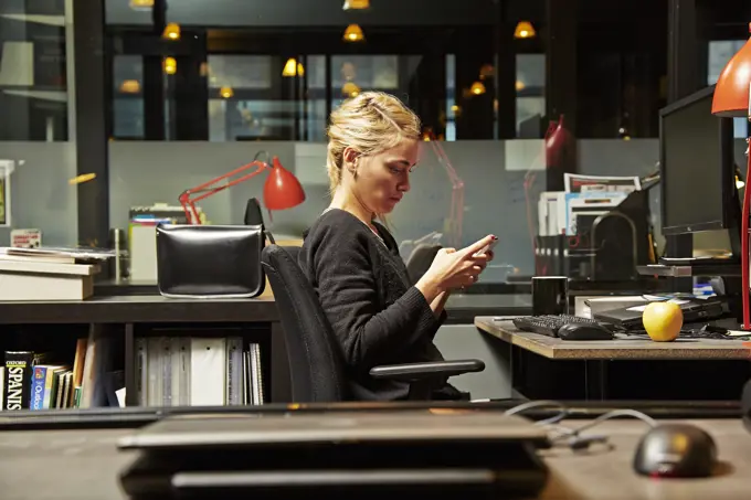 Focused professional working late in a modern office.