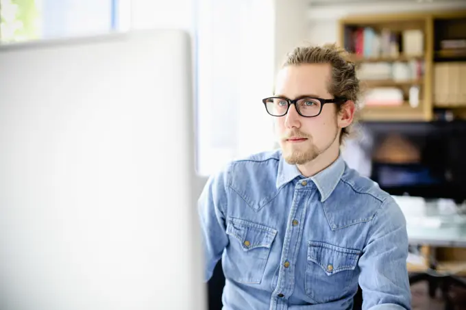 Young professional working intently at his computer