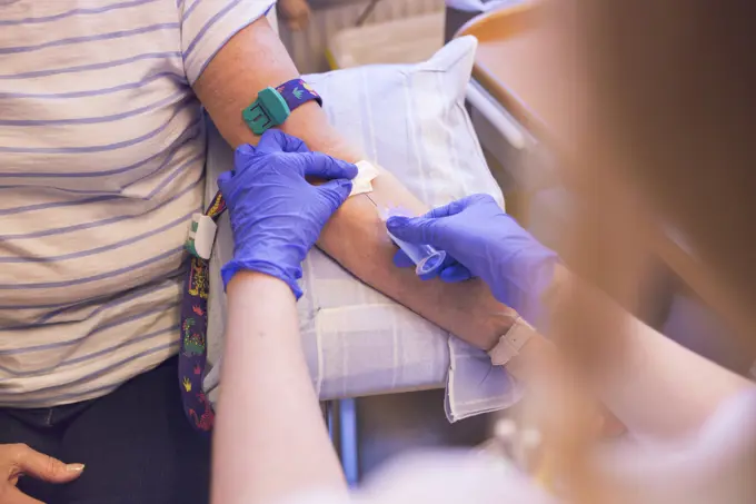 A patient receiving a blood test in a medical setting