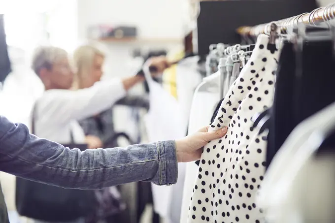 Shopping for the perfect outfit among racks of clothes