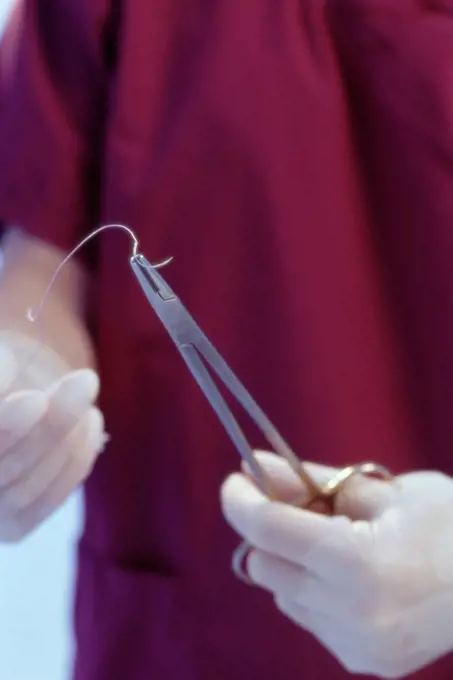 Surgeon preparing stitches