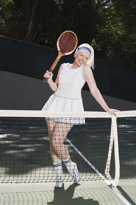 Senior adult woman on tennis court