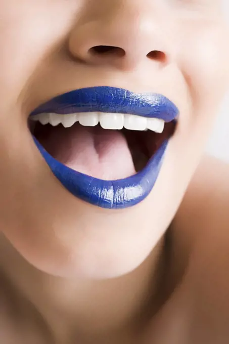 A woman wearing blue lipstick