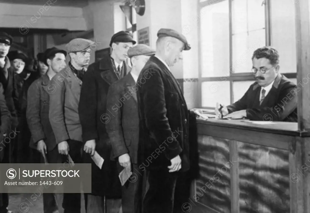 Group of men standing in an unemployment line, Weimar Republic, Germany, 1930