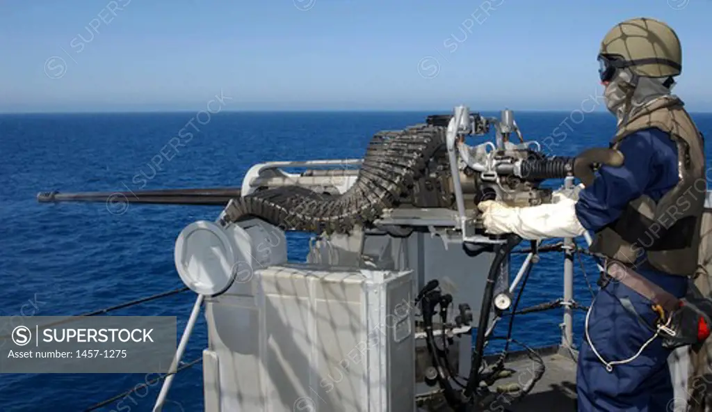 U.S. Navy Gunner's Mate fires a .50-caliber machine gun during weapons training aboard USS Boxer (LHD-4)