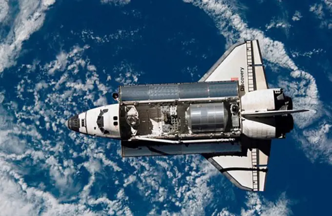 Satellite view of a space shuttle with earth in the background, Space Shuttle Discovery, July 28, 2005