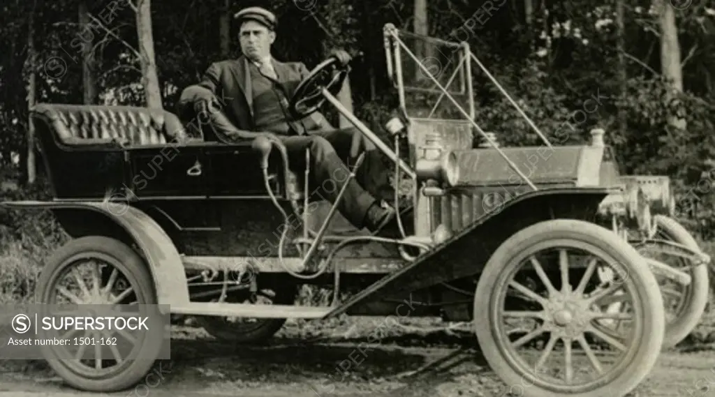 Mature man sitting in a vintage car