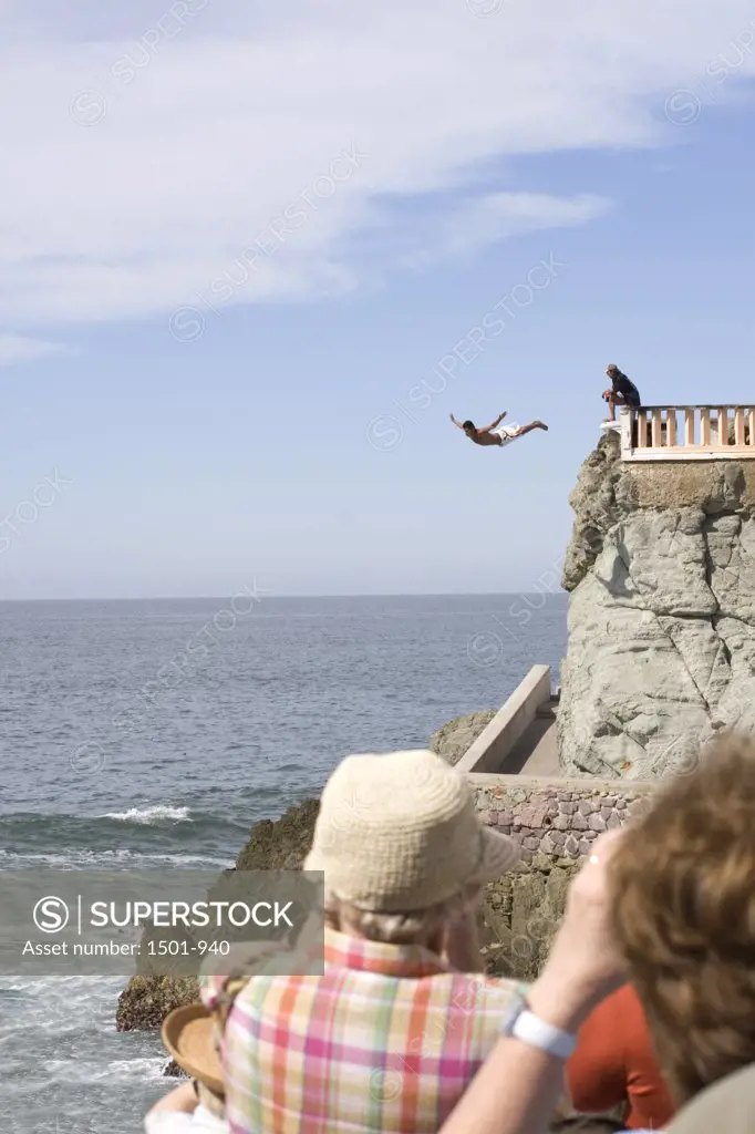 Person diving from a cliff into the sea, Olas Altas Beach, Mazatlan, Sinaloa, Mexico