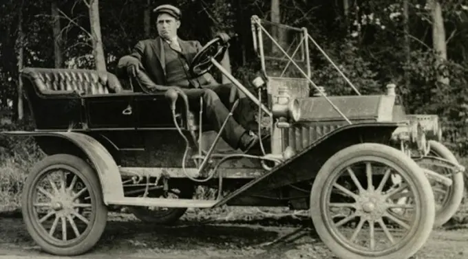 Mature man sitting in a vintage car