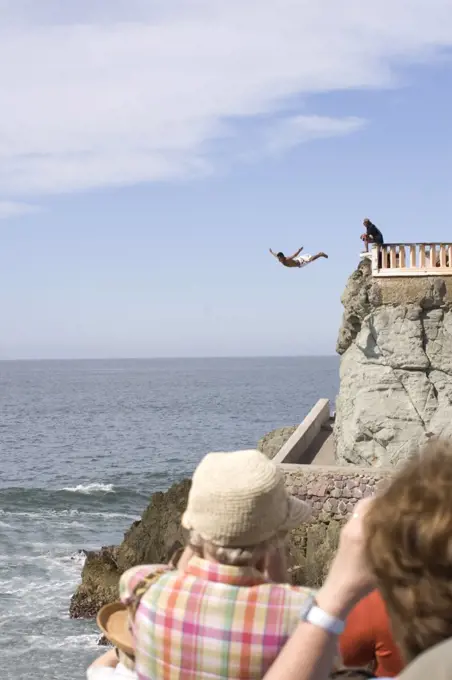 Person diving from a cliff into the sea, Olas Altas Beach, Mazatlan, Sinaloa, Mexico