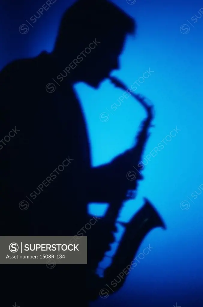 Silhouette of a man playing the saxophone