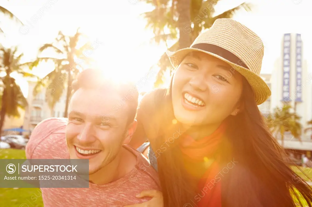 Young Couple Having Fun In Park Together