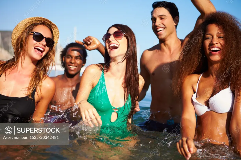 Group Of Young Friends Having Fun In Sea Together