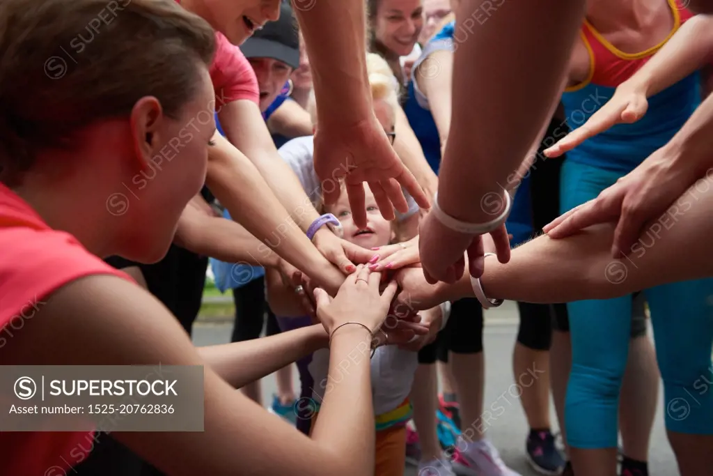 jogging people group, friends have fun,  hug and stack hands together after training