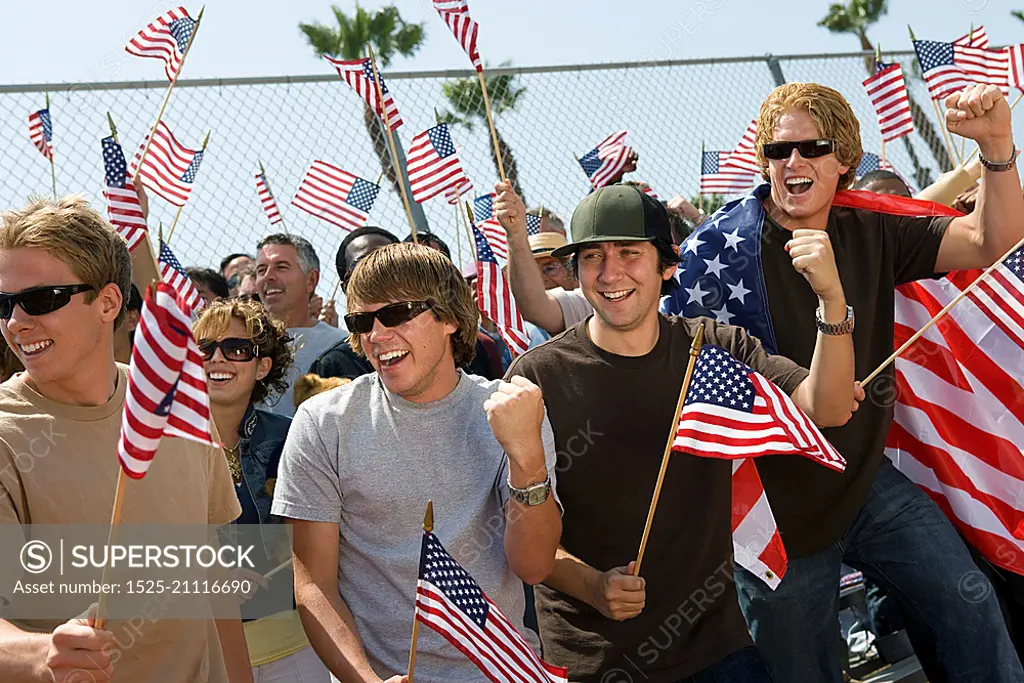 Crowd holding up American flags