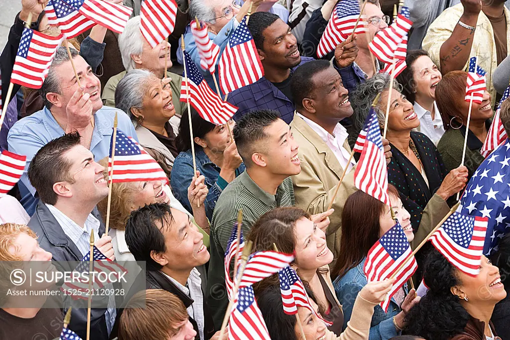 Crowd holding American flags