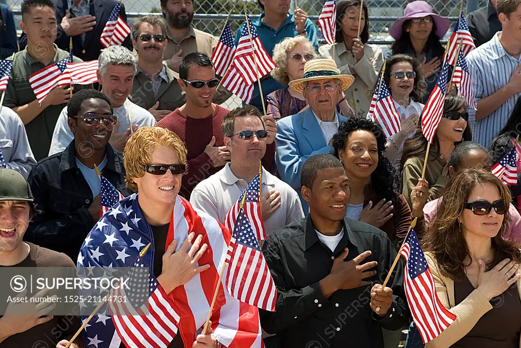 Crowd holding American flags