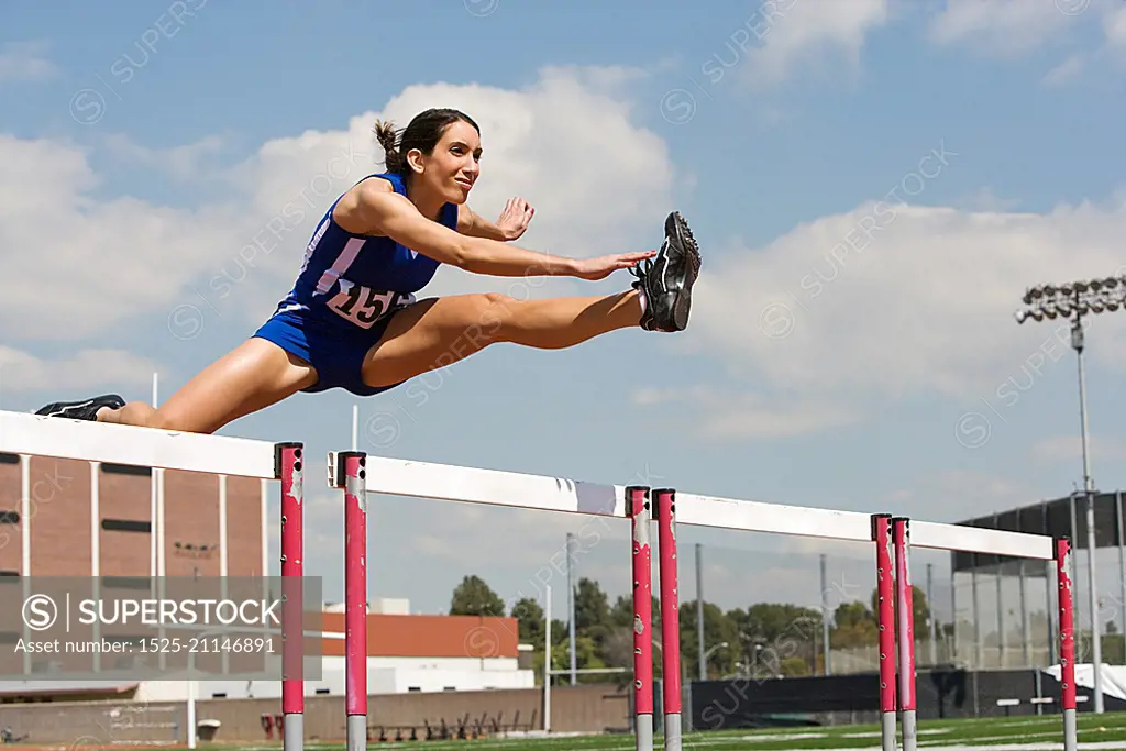 Female athletes hurdling