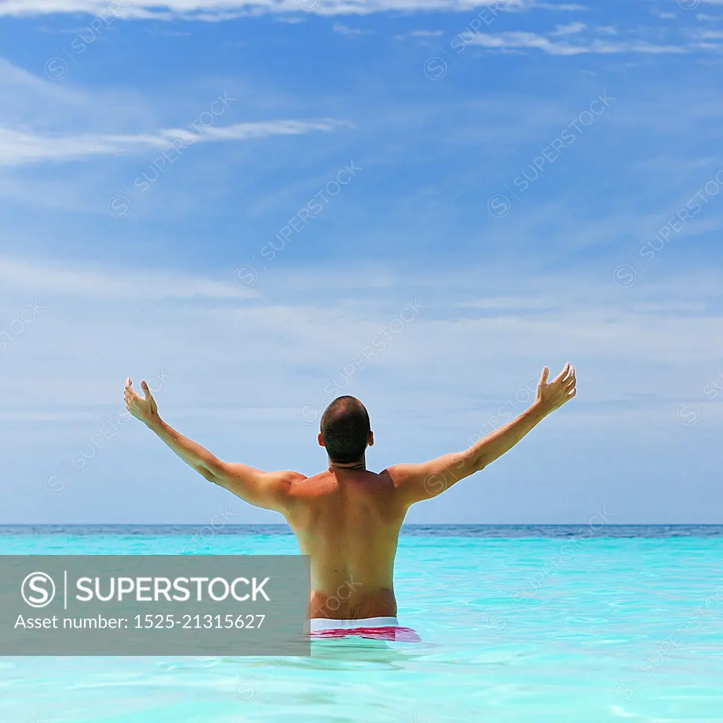 Man in water at tropical beach