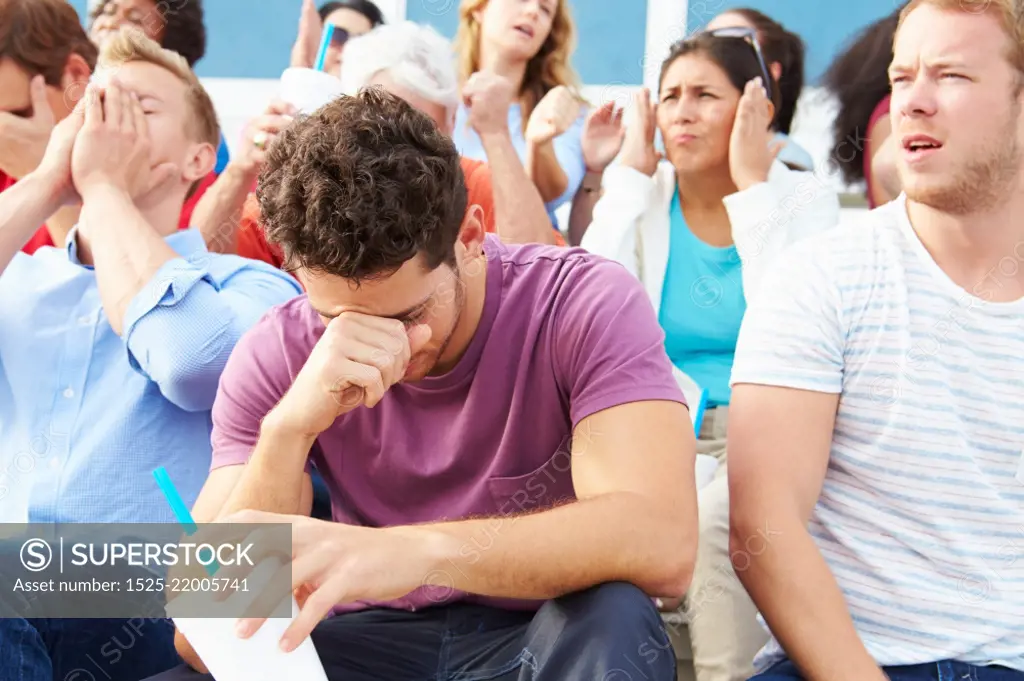 Disappointed Spectators At Outdoor Sports Event