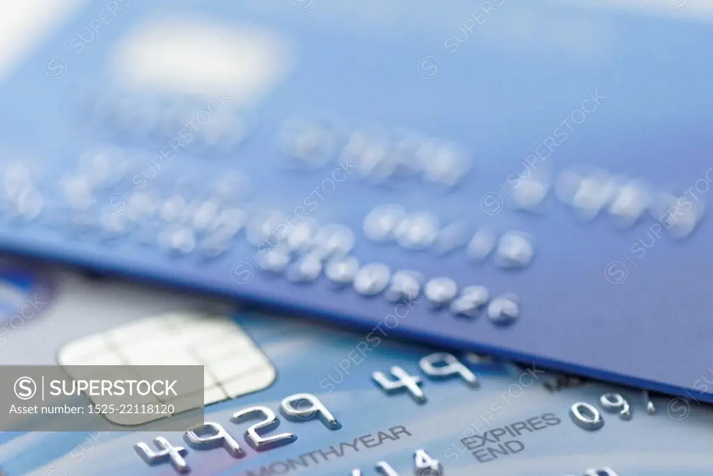 Extreme close up of part of a credit card with shallow depth of field. Account number changed for security