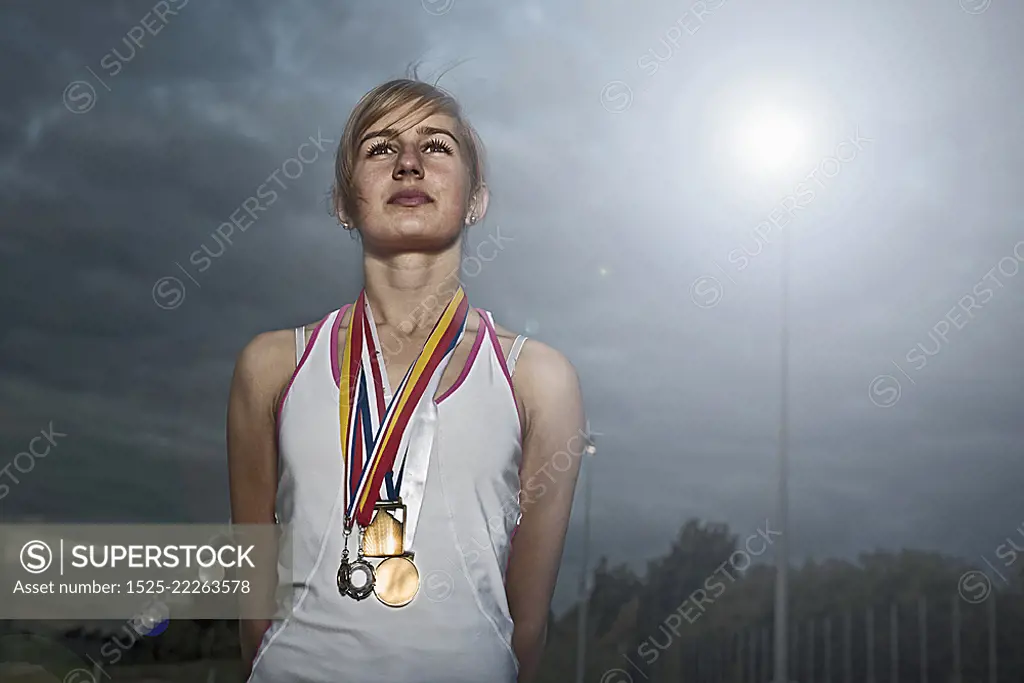 portrait of female athlete with medals