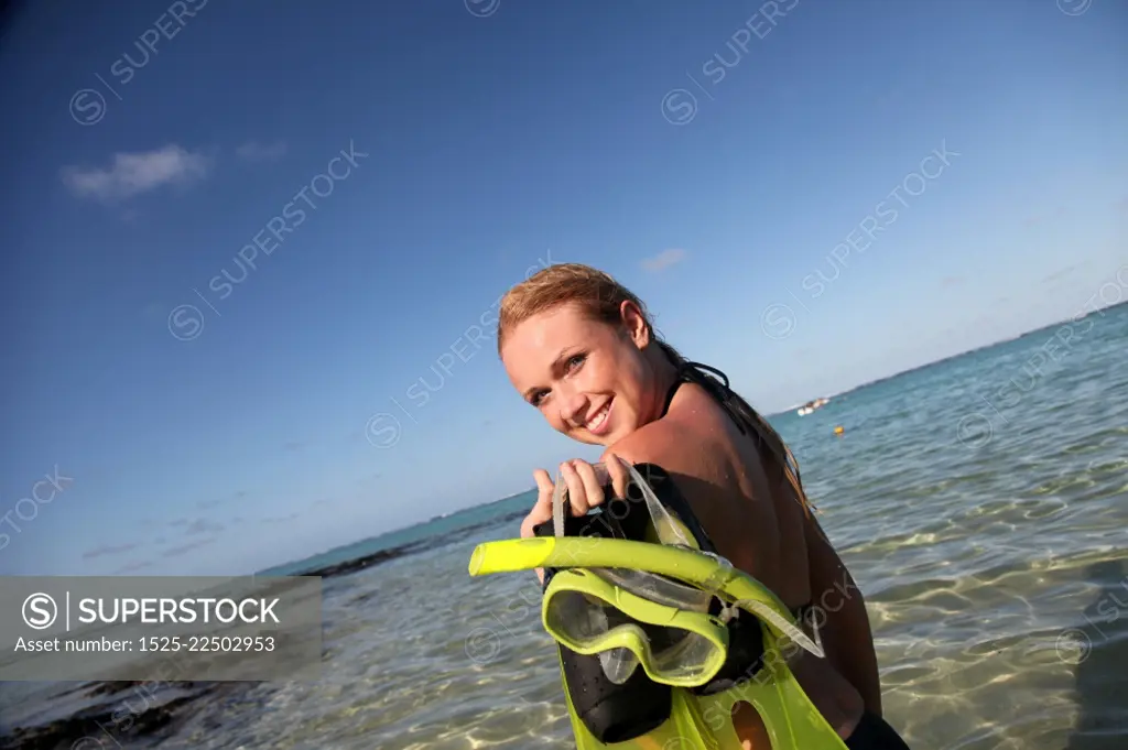 Woman getting out of water after snorkeling journey