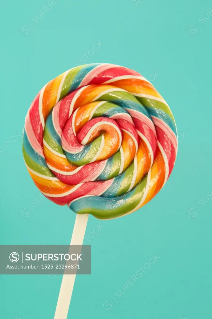 Nice lollipop with many colors in a spiral on a blue background