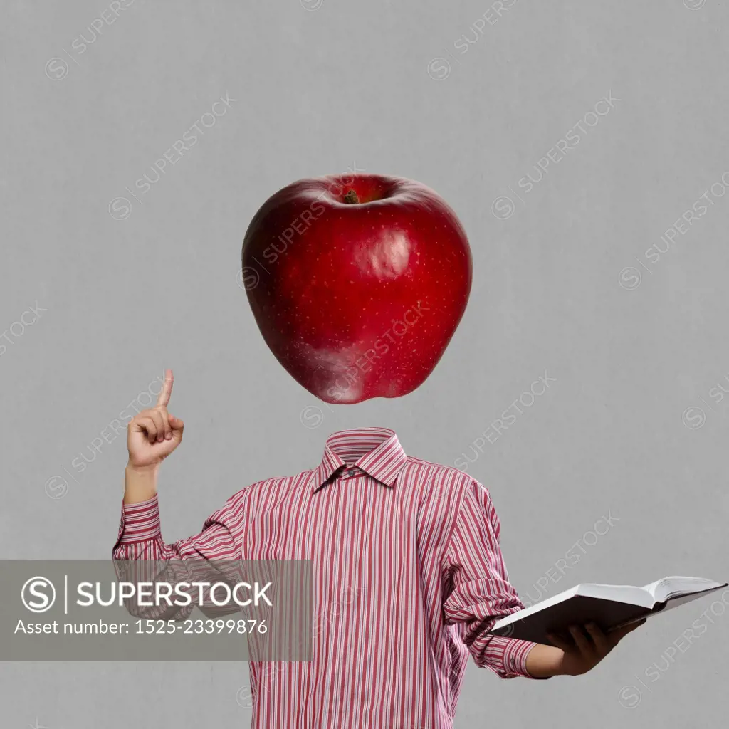 Great mind. Businessman with book in hand and apple instead of head