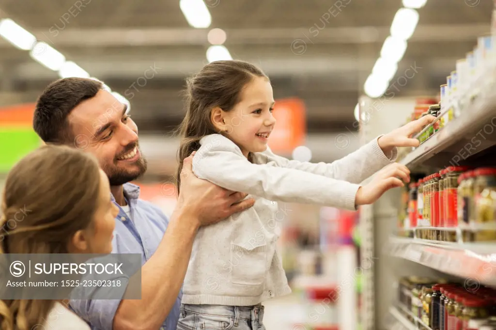 sale, shopping, consumerism and people concept - happy family with child buying food at grocery store or supermarket