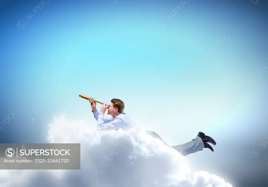 Business break. Young businessman flying in sky and lokking in spyglass