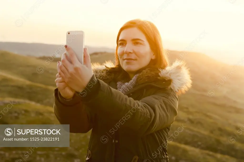 Beautiful woman in outdoor making a selfie