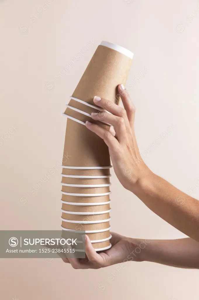 close up hands holding paper cups