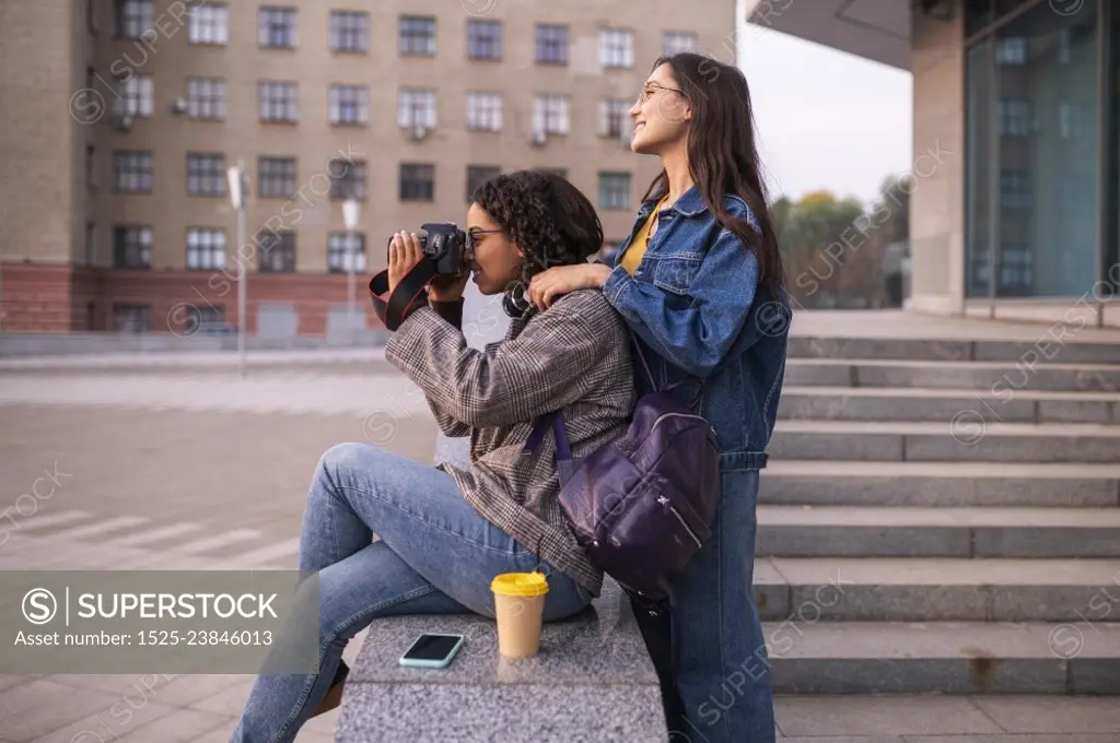 friends having fun together outdoors with camera