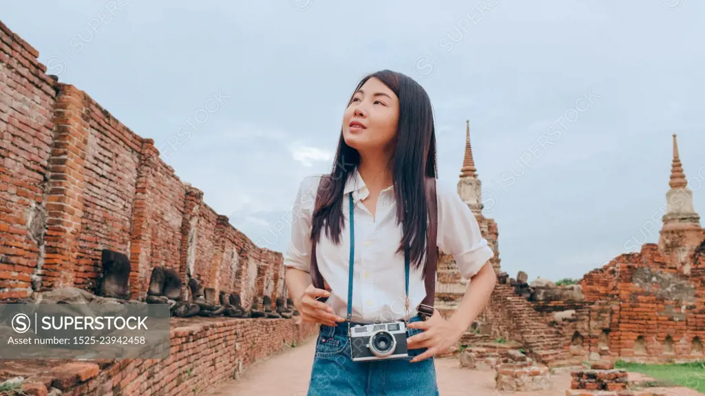 Traveler Asian woman spending holiday trip at Ayutthaya, Thailand, Japanese backpacker female enjoy her journey at amazing landmark in traditional city. Lifestyle women travel holidays concept.