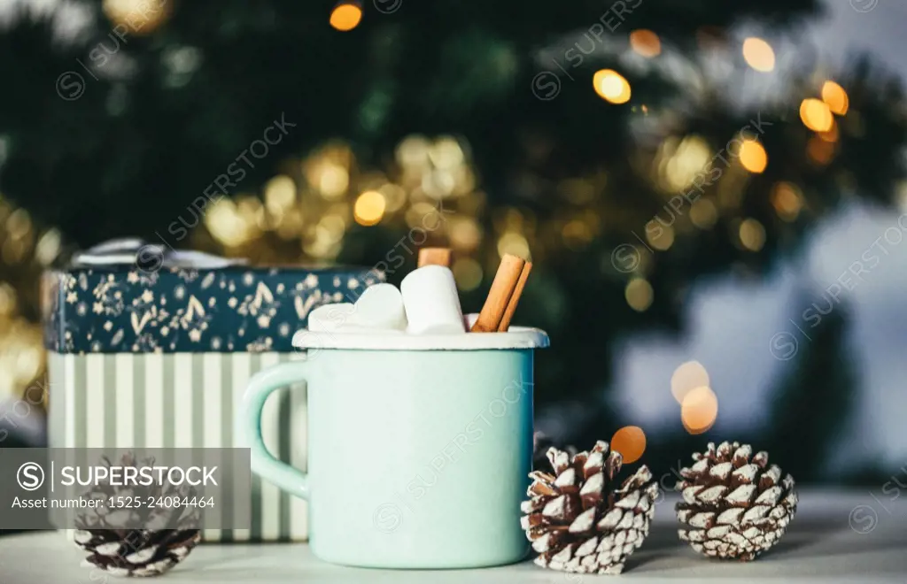 hot chocolate with marshmallow and Christmas lights cozy winter drink