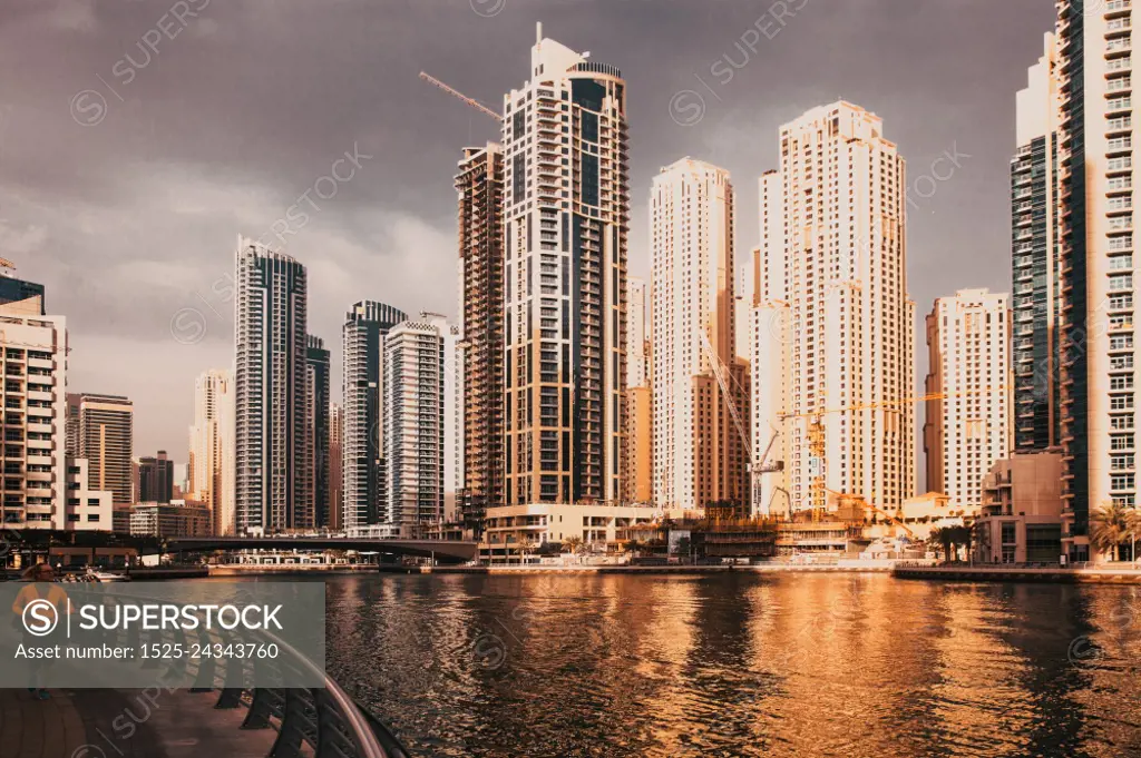 DUBAI, UAE - FEBRUARY 2018: View of modern skyscrapers shining in sunrise lights  in Dubai Marina in Dubai, UAE.