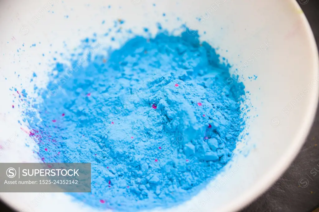 overhead view blue colored powder white bowl