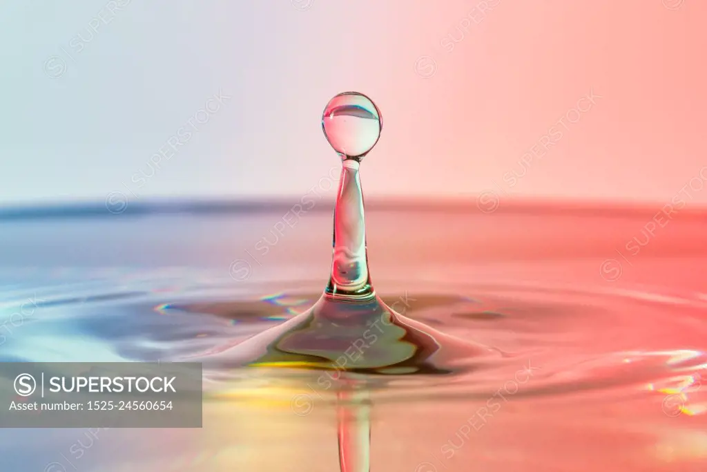 High speed water drop photograph, pillar with blue, red and yellow colors. High speed water drop photograph with blue and red colors