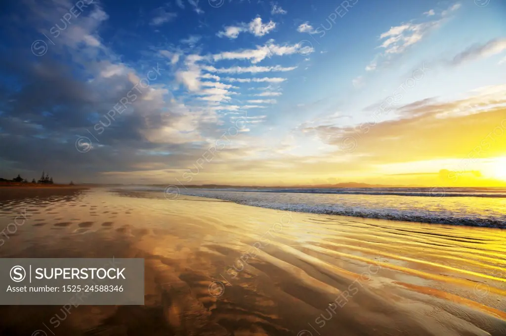 Beautiful Sunset at the Ocean Beach, New Zealand. Inspiring natural and travel background