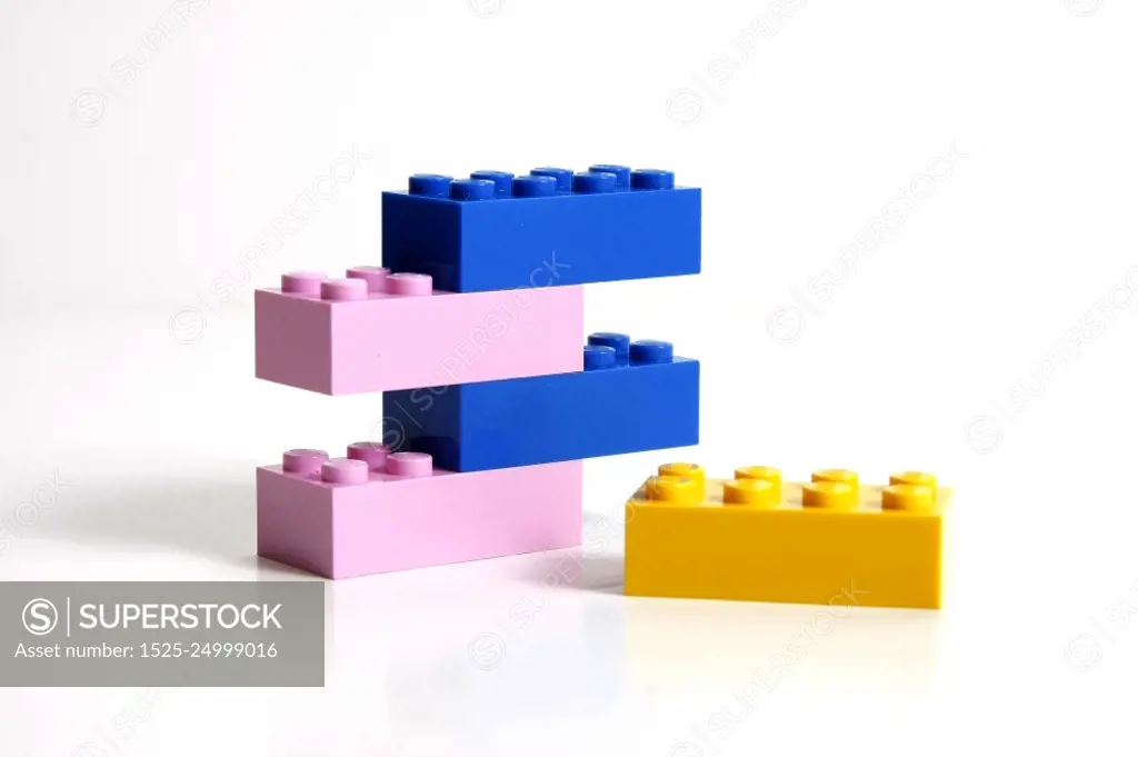 One yellow block and a stack of blue and pink ones.