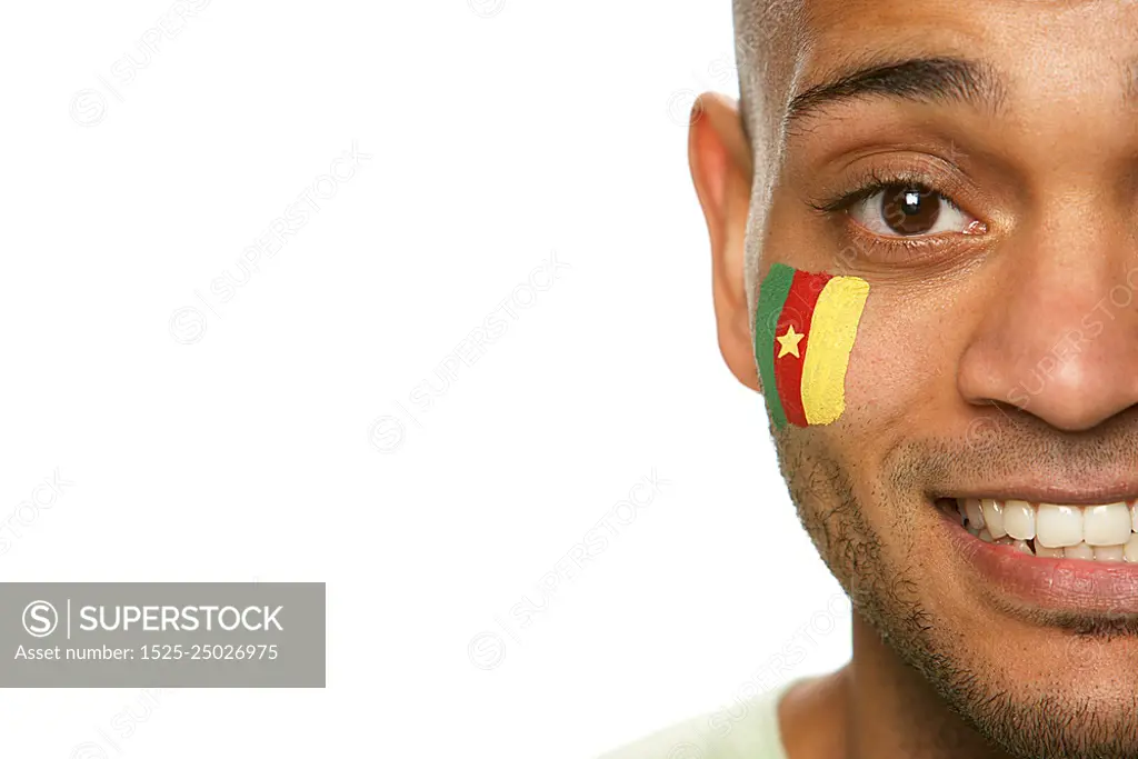 Young Male Sports Fan With Cameroon Flag Painted On Face